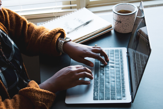 A woman typing on her laptop